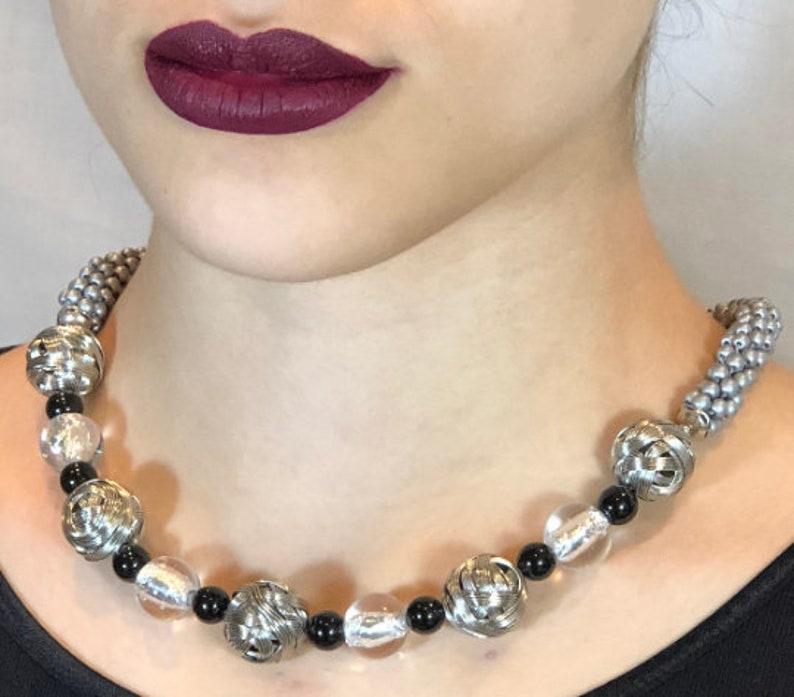 Sides are made in bead crochet silver. stainless woven beads with black and silver foil accent beads Avant-garde necklace Beaded Necklace