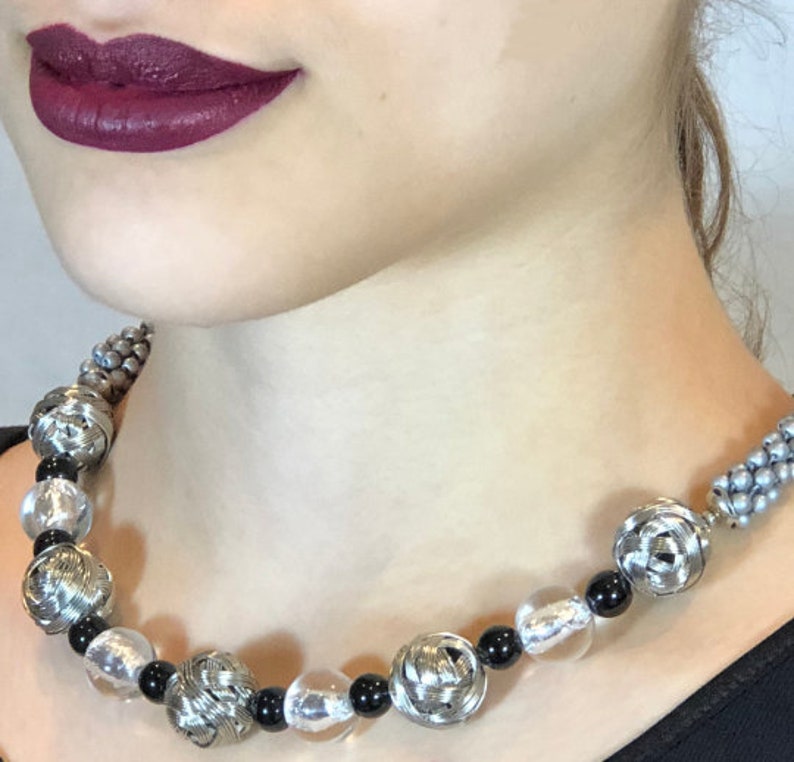 Sides are made in bead crochet silver. stainless woven beads with black and silver foil accent beads Avant-garde necklace Beaded Necklace