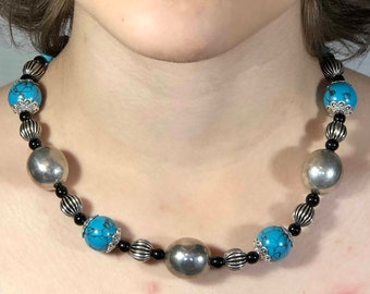 Beaded necklace. Charming necklace made of turquoise and pewter beads with black glass accent beads.