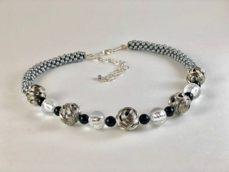 Sides are made in bead crochet silver. stainless woven beads with black and silver foil accent beads Avant-garde necklace Beaded Necklace