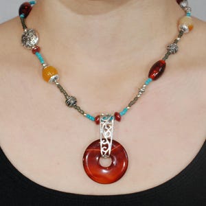 Beaded necklace. Glass beads. Agate beads. Pewter beads. Amber-colored pendant.