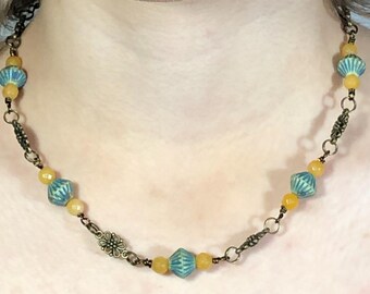 Beaded necklace. Pale green Czech glass beads. Yellow jade beads. Bronze flower beads. Bronze findings.