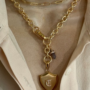 Personalized shield and spike gemstone necklace