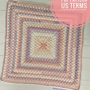 May include: A crochet blanket with a square pattern in shades of pink, beige, and purple. The blanket is made with a textured stitch and has a border around the edges. The text "PDF PATTERN US TERMS" is written in a circle on the top right corner of the image. The text "@KNITKNOTING" is written in the bottom right corner of the image.