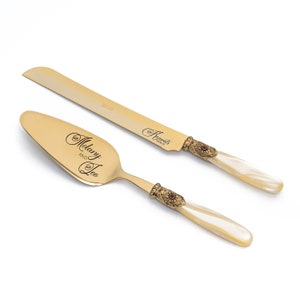 Gold Cake Server and Knife Cutting Set for Wedding with Ivory Pearl Handle Antique Gold Washed Metal Ring with a Red Stone Decoration