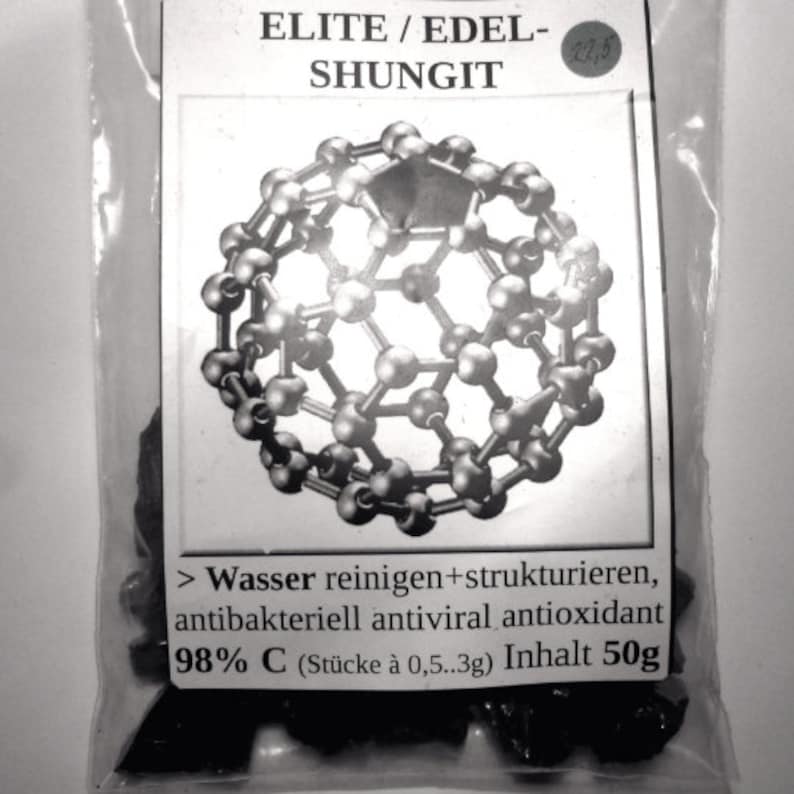 K&ouml;nnte beinhalten: Eine Nahaufnahme einer kleinen T&uuml;te mit schwarzen Shungit-Steinen. Die T&uuml;te ist mit "ELITE/EDEL-SHUNGIT" und "98% C (St&uuml;cke &agrave; 0,5..3g) Inhalt 50g" beschriftet. Die T&uuml;te zeigt auch eine Schwarzwei&szlig;illustration eines Fullerens.