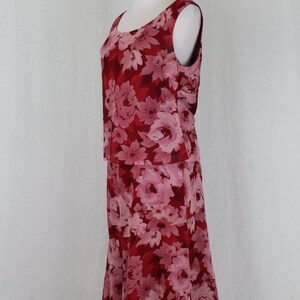 May include: A red and pink floral print sleeveless dress with a fitted bodice and a flowing skirt.