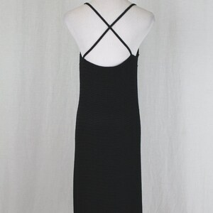May include: Black midi dress with a criss-cross strap back.