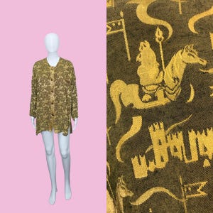 May include: A long-sleeved, button-down shirt in shades of olive green and tan, displayed on a mannequin. The fabric has a textured pattern. A close-up reveals a gold-colored medieval-themed fabric with knights, horses, and castles.
