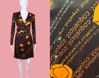 Vestido corto de manga larga estilo disco de los años 70 de Bird's Nest en Smith's. Estampado floral de amapolas por toda la prenda en negro y naranja. Talla pequeña. Tal cual.