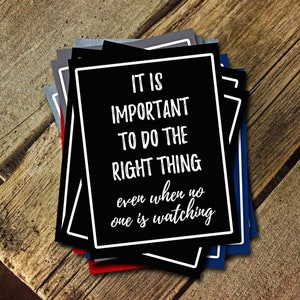 May include: A stack of black cards with white text that reads "It is important to do the right thing even when no one is watching."