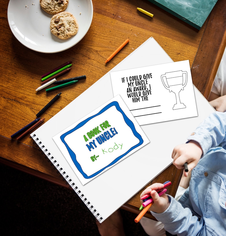 May include: A white printable book cover with blue and green borders. The text on the cover reads "A Book for My Uncle!" with the name "Kody" written below. A separate white printable card with a trophy outline and the text "If I could give my uncle an award, I would give him the" is also visible.