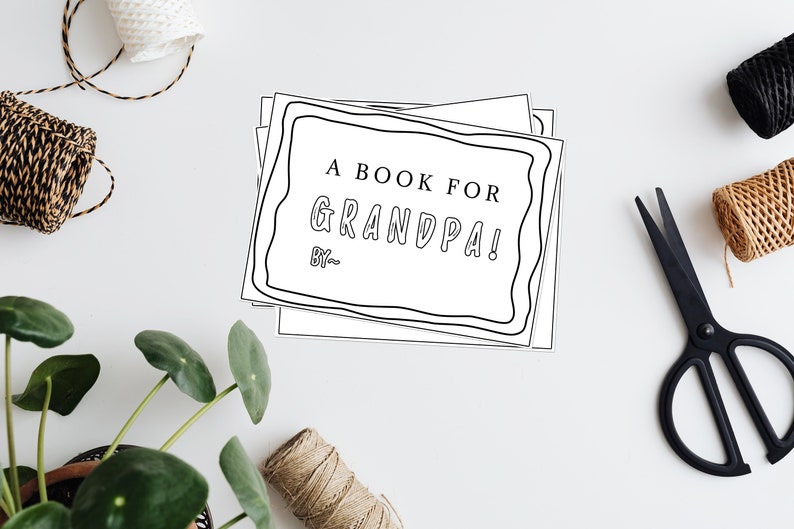 May include: A stack of blank white pages with a black border and the text "A Book for Grandpa! By--" on the top page.