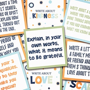 May include: A set of colorful cards with writing prompts for journaling or creative writing exercises. The prompts include topics like kindness, love, gratitude, and scary experiences.