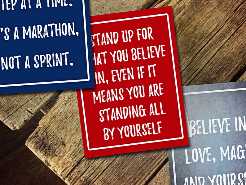 May include: Three inspirational quotes printed on colorful cards. The first card is blue with white text that reads "It's a marathon, not a sprint." The second card is red with white text that reads "Stand up for what you believe in, even if it means you are standing all by yourself." The third card is blue with white text that reads "Believe in love, magic and yourself."