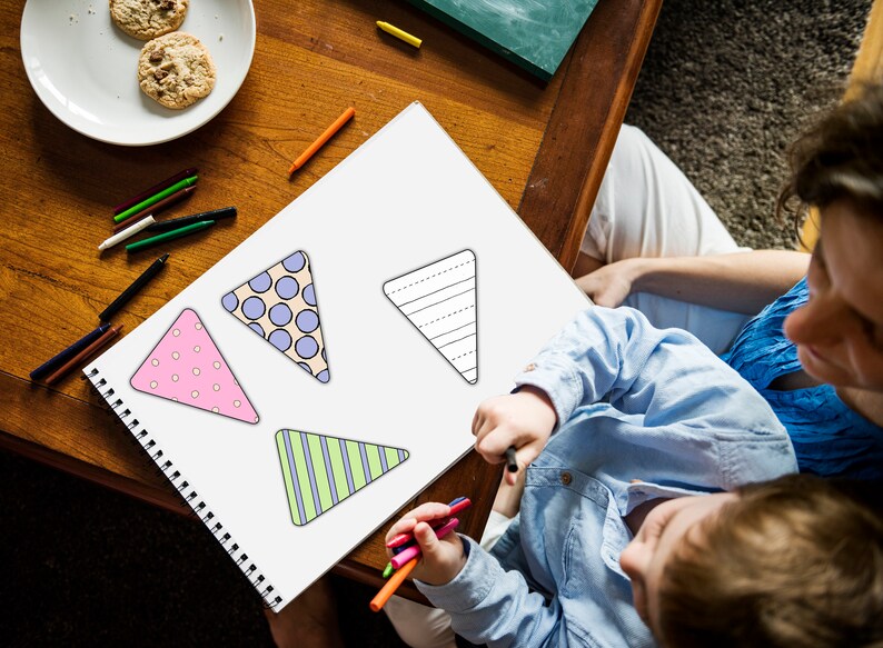 A child is seen sitting at a table with crayons in his hands, coloring in the Printable Easter Banner.