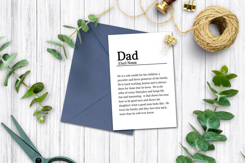 May include: A white card with black text that defines the word "Dad" as a noun. The text reads, "He is a role model for his children, a provider and fierce protector of his family. He is hard working, honest and is always there for those that he loves. He is the seller of corny Dad jokes and keeps life fun and interesting. A Dad shows his sons how to be good men and shows his daughters what a good man looks like. He loves his family and they love him back, more than he will ever know."