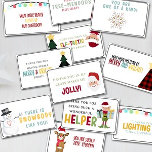 May include: A collection of Christmas-themed gift tags with various festive messages and illustrations. The tags feature phrases like "Merry & Bright," "Jolly," and "Elf-tastic," along with images of Santa, elves, and snowmen. Red ribbon and ornaments are scattered around.
