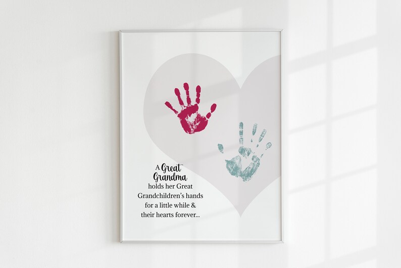 May include: A framed print with a heart shape and two handprints, one red and one blue. The print includes the text "A Great Grandma holds her Great Grandchildren's hands for a little while & their hearts forever..."