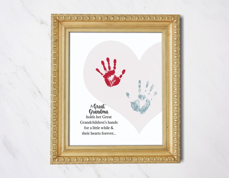May include: A framed print with a heart shape and two handprints, one red and one blue. The text reads "A Great Grandma holds her Great Grandchildren's hands for a little while & their hearts forever..."