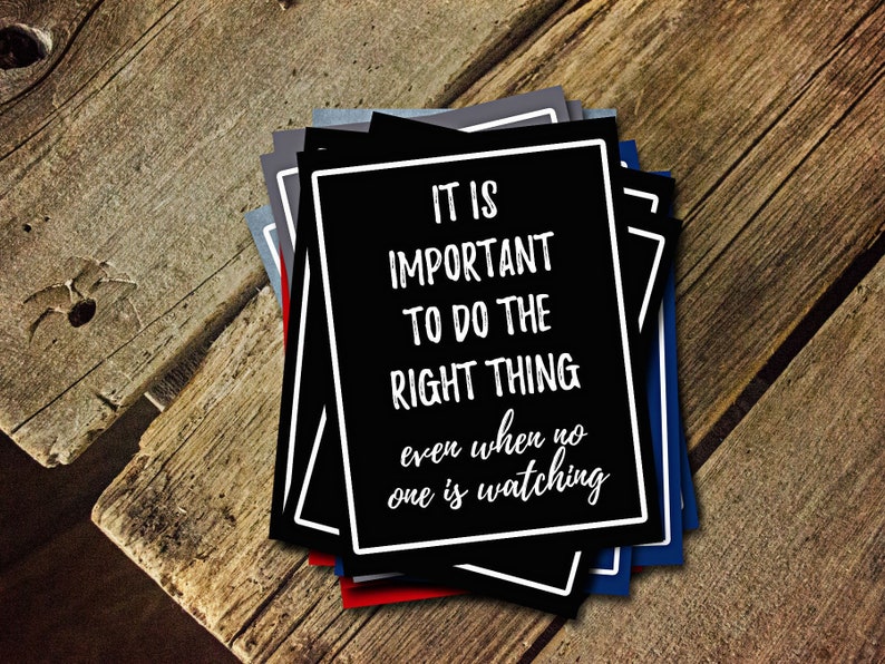 May include: A stack of black cards with white text that reads "It is important to do the right thing even when no one is watching."