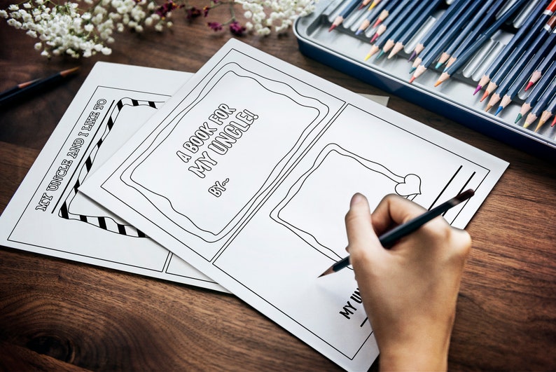 May include: A blank book with the title "A Book for My Uncle!" and the words "By:___" written on the cover. A person is drawing a heart in a frame on the page.