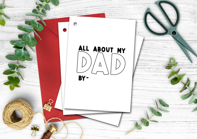 May include: White card with black text that reads "All About My Dad" with the word "Dad" in large, outlined letters. The text "By-" is below the word "Dad".