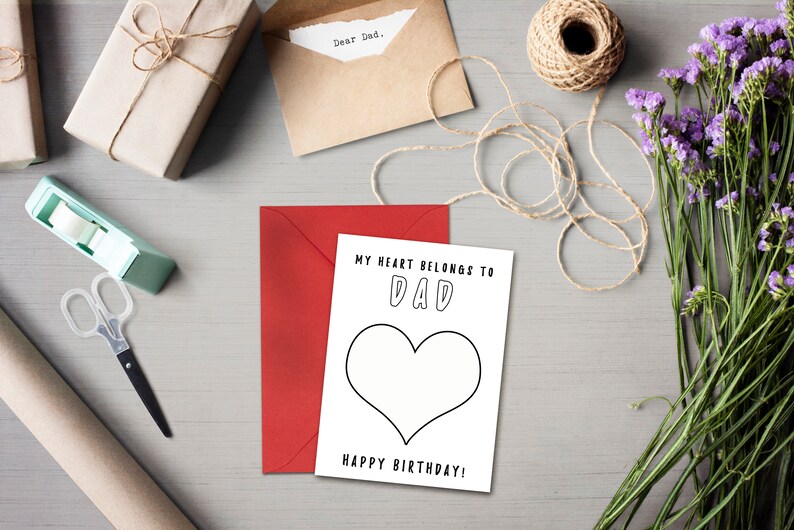 May include: A white card with black text that reads "My heart belongs to Dad" with a large heart outline. The text "Happy Birthday!" is at the bottom of the card.