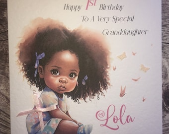 May include: A birthday card with a pink and white ribbon, a drawing of a young girl with dark brown hair and brown eyes, and the text "Happy 1st Birthday To A Very Special Granddaughter Lola".