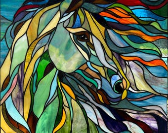 May include: A stained glass artwork depicting a horse's head with flowing mane and a blue eye. The horse is rendered in shades of blue, green, yellow, and orange.