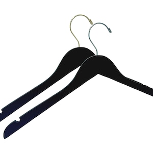 May include: Two black wooden hangers with gold and silver hooks. The hangers are designed for clothes with a curved shape and a notch at the bottom.
