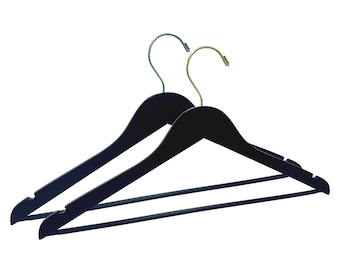 May include: Two black wooden hangers with metal hooks. One hook is silver and the other is gold.