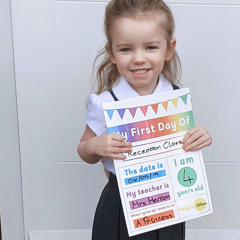 May include: A colorful printable sign for a child's first day of school. The sign has a rainbow banner at the top and includes the text "My First Day Of Reception Class". The sign also includes spaces to fill in the date, the child's age, the teacher's name, and what the child wants to be when they grow up. The sign is filled out with the date "04/09/19", the child's age "4", the teacher's name "Mrs Herron", and the child's future aspiration "A Princess".