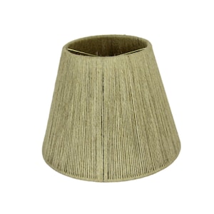 May include: A natural-toned lampshade made of woven jute rope. The shade has a classic bell shape and is designed for a standard lamp base.