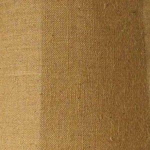 May include: A close-up of a brown burlap fabric with a slightly lighter brown vertical stripe running down the center.
