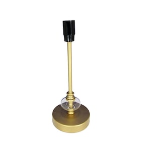May include: A gold metal ceiling light fitting with a black socket and a clear glass globe. The fitting has a round base.