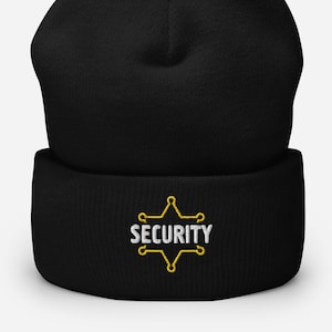Könnte beinhalten: Schwarze Mütze mit einem goldenen gestickten Stern und dem Wort "SECURITY" in weißen Buchstaben.