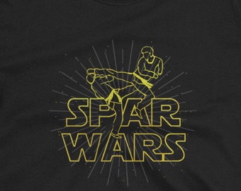 May include: Black t-shirt with a yellow graphic of two people sparring. The text "SPAR WARS" is written in yellow below the graphic.
