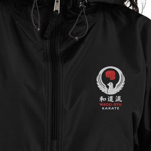 May include: Black windbreaker jacket with a white embroidered logo that says "和道流 WADO-RYU KARATE".