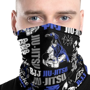 May include: A black face mask with a blue and white pattern featuring the words "Jiu-Jitsu" and "Tap, Snap, Tap".