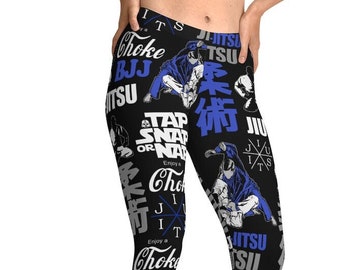 Puede incluir: Leggins negros con un estampado azul y blanco de texto e imágenes relacionadas con las artes marciales. El texto incluye "Choke", "BJJ", "Tap or Snap", "Jitsu" y "術".