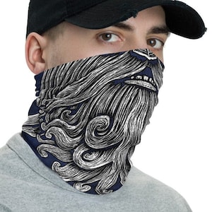 May include: A navy blue face mask with a white and grey graphic of a beard. The beard is styled to look like waves.