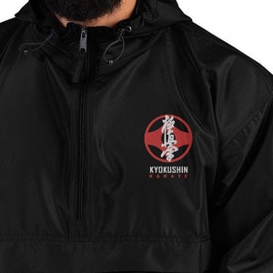 May include: A black windbreaker jacket with a red and white Kyokushin Karate logo embroidered on the chest.