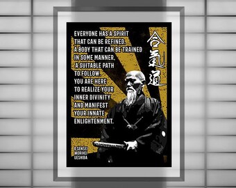 May include: A black and white poster with a yellow and black background. The poster features a quote by O'Sensei Morihei Ueshiba, the founder of Aikido, and a portrait of him. The quote reads: "Everyone has a spirit that can be refined, a body that can be trained in some manner, a suitable path to follow. You are here to realize your inner divinity and manifest your innate enlightenment."