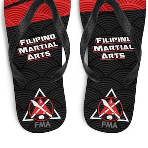 May include: Black flip-flops with a red and black wave pattern. The flip-flops have the text "FILIPINO MARTIAL ARTS" and "FMA" printed on them.