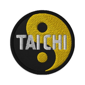 May include: Black and yellow embroidered patch featuring a yin yang symbol and the word "TAICHI" in white.