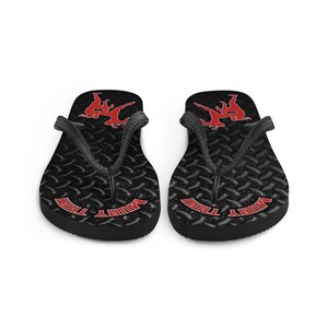 May include: Pair of black flip flops with a red Muay Thai graphic and the words "Muay Thai" on the straps.