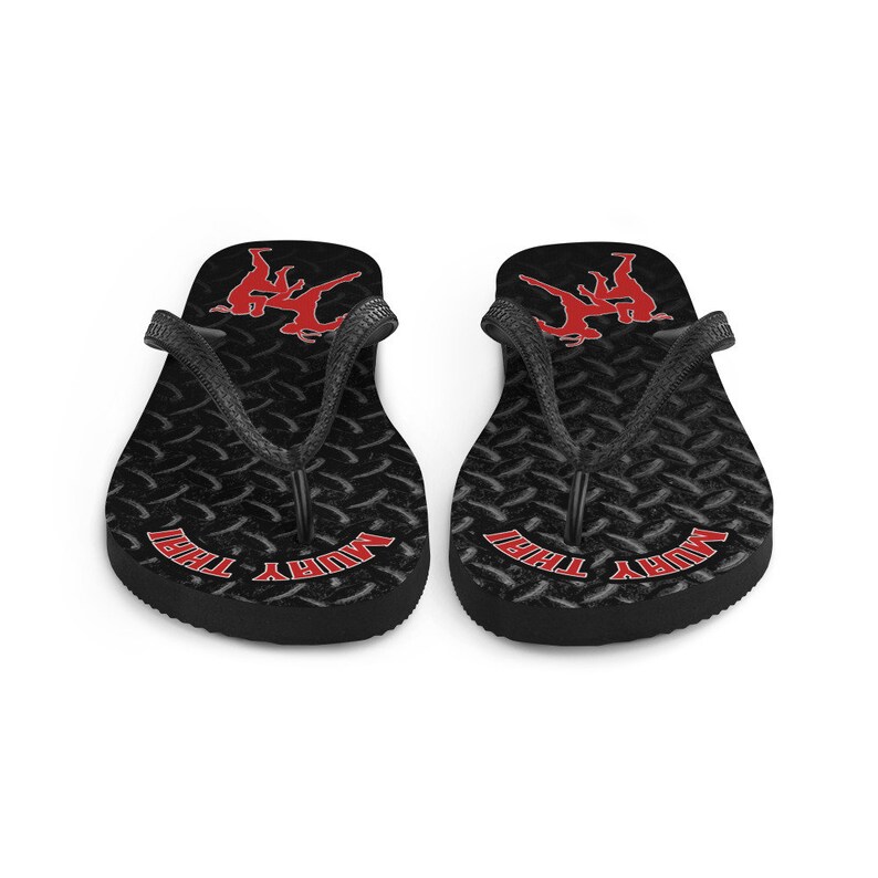 May include: Pair of black flip flops with a red Muay Thai graphic and the words "Muay Thai" on the straps.