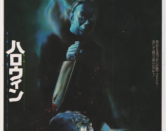 May include: A vintage movie poster for the horror film "Halloween." The poster features a menacing figure holding a bloody knife over a screaming person. The background is dark with a lightning bolt and text in Japanese.