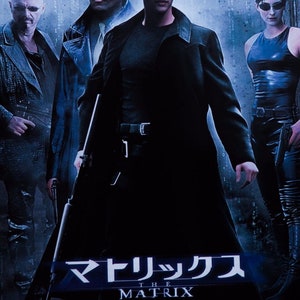 May include: A movie poster for "The Matrix" featuring Keanu Reeves, Laurence Fishburne, Carrie-Anne Moss, and Hugo Weaving. The poster is in Japanese and features the title "The Matrix" in English and Japanese.